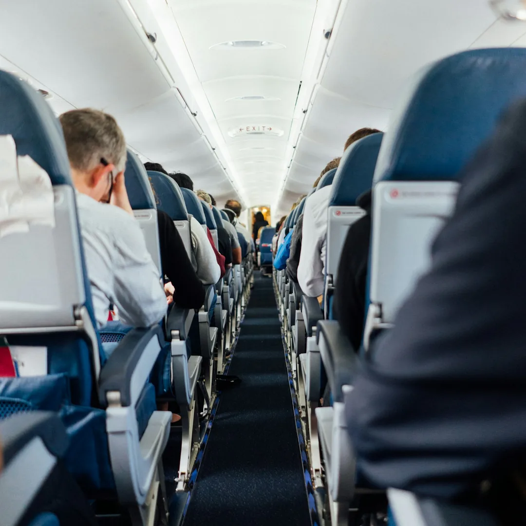 Airplane wing above the clouds — long-haul Premium flight